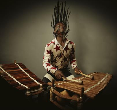 Photo of a man playing a wooden percussion instrument